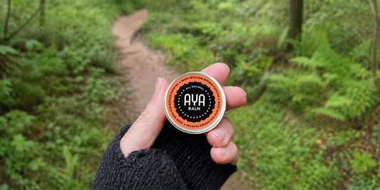 AYA Balm held on a forest trail in winter - natural skincare Plettenberg Bay