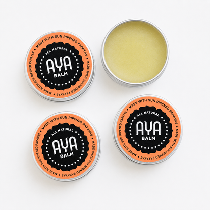 AYA Balm 4-pack flat lay - four 15g tins with one open showing pale yellow natural balm made with raw fermented papaya