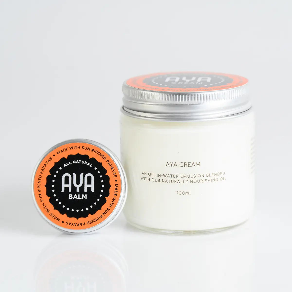 AYA Cream 100ml oil-in-water emulsion jar with AYA Balm all natural sun ripened papaya tin side view