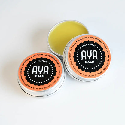  AYA Balm open tin showing natural pale yellow balm texture - made with beeswax, sweet almond oil and raw fermented papaya