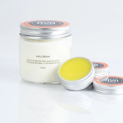AYA Cream 100ml jar with AYA Balm tins open showing natural papaya balm texture
